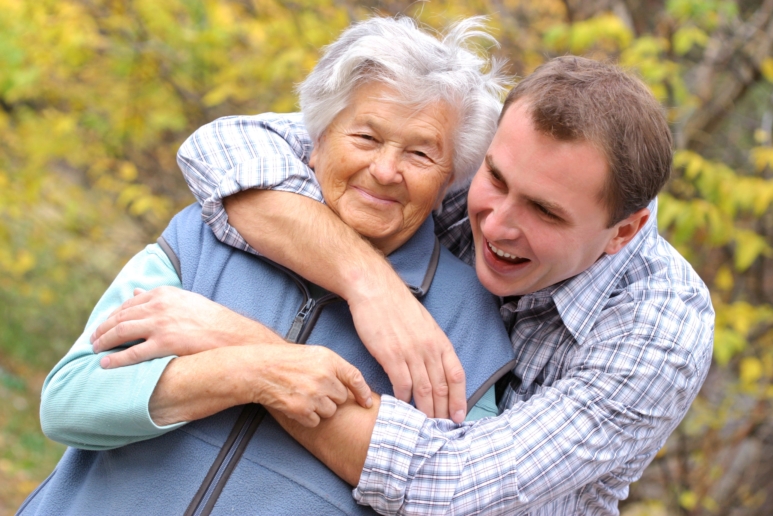 Young man hugging senior woman